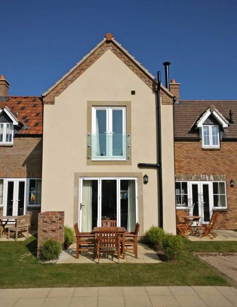 Rear of Beach Haven Cottage with BBQ and South facing patio.