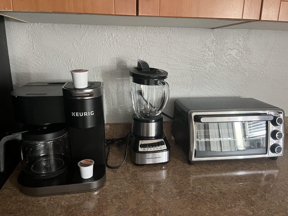 fullly stocked with pots, pans, coffee, coffeemaker, dishes, cleaning supplies 