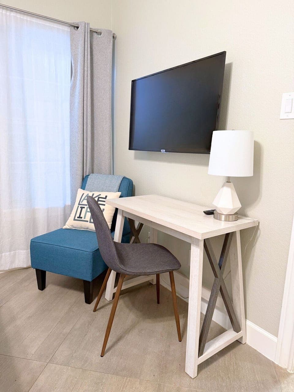 Mix lake days with workdays—this luxury Lake Travis condo includes a simple desk setup and wall-mounted TV for easy remote work.