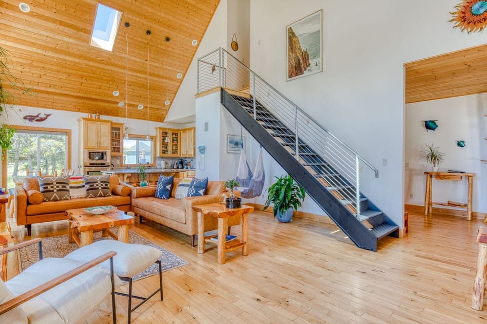 The great room is bathed in natural light and filled with live house plants