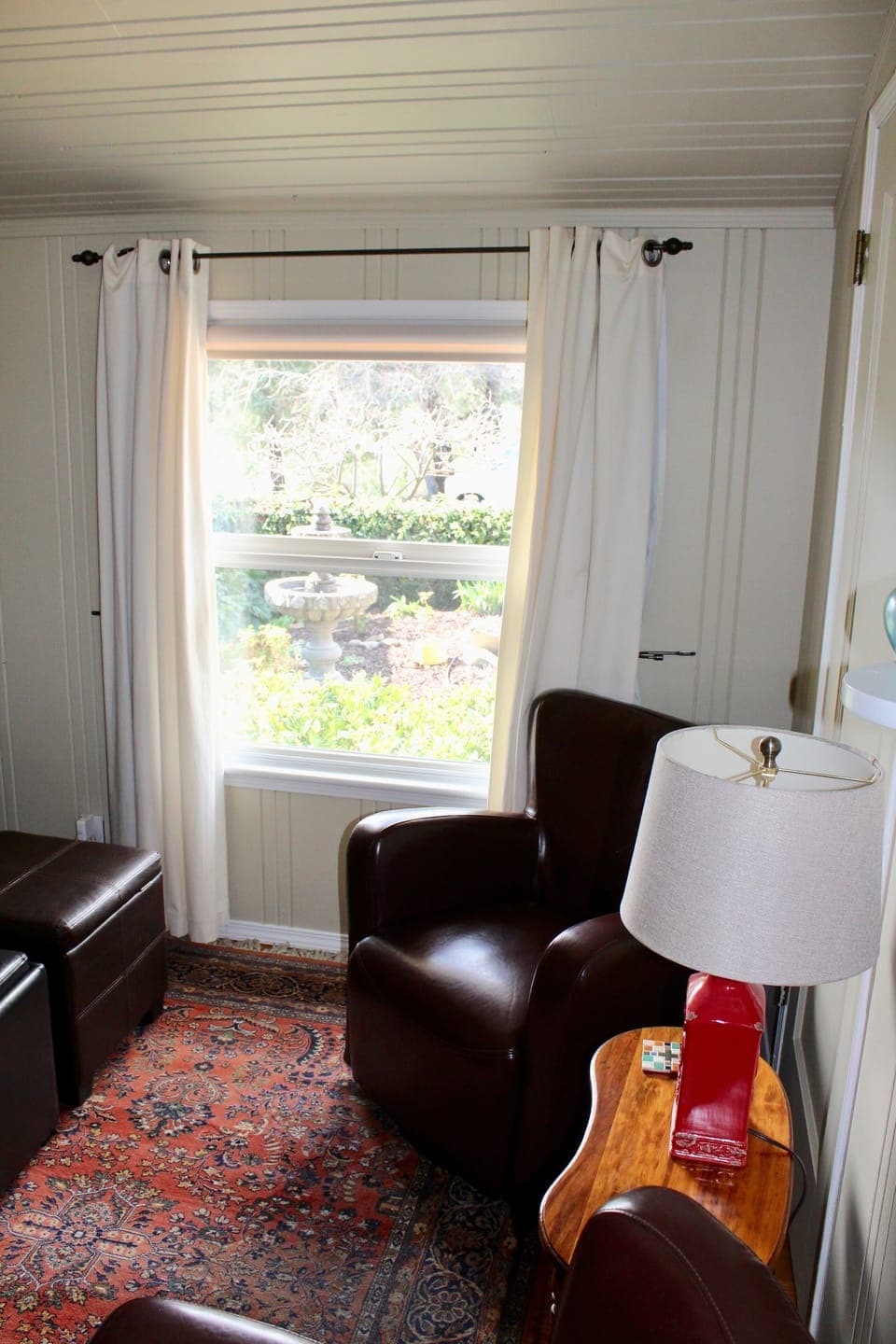Den with a view of the front courtyard fountain