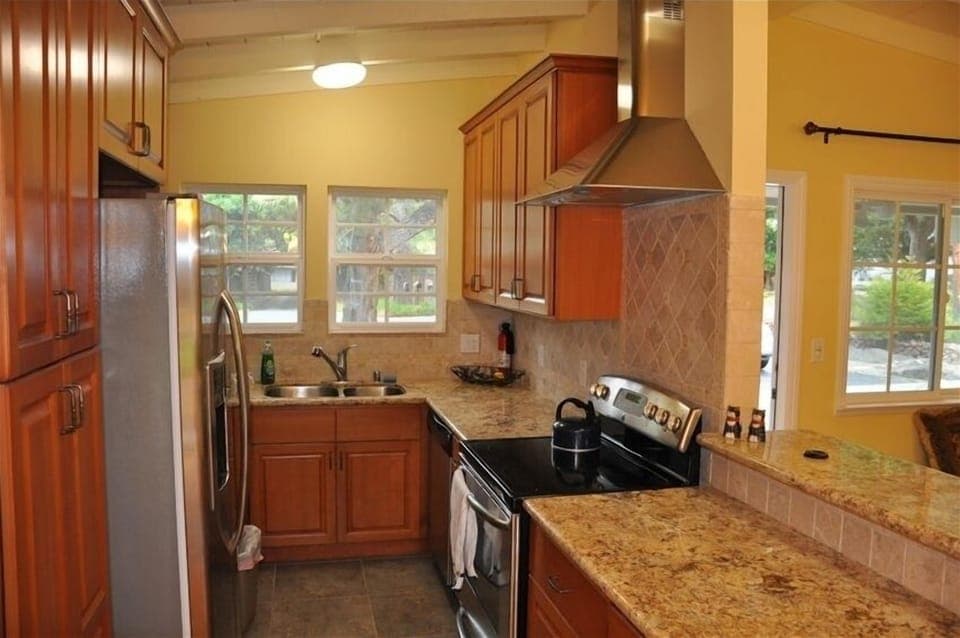 New kitchen with granite counter and stainless steel appliances