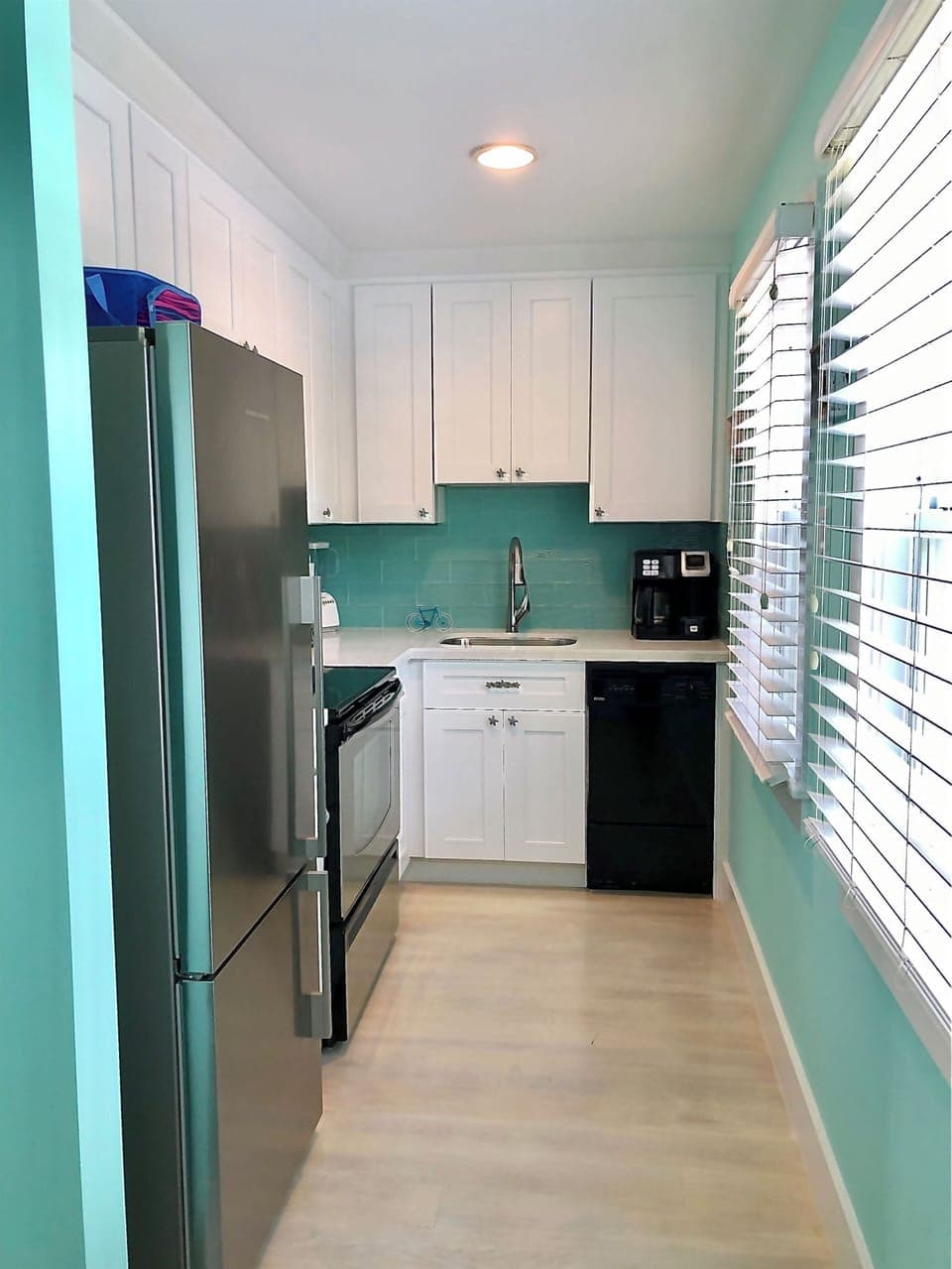Kitchen - Bright kitchen with SS appliances, Silestone countertops and turquoise glass backsplash