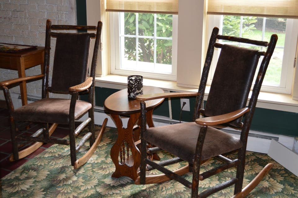 Two rocking chairs are perfect for relaxing with view of pond out the window.