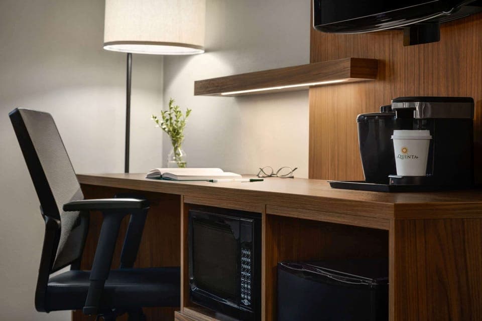 Premium bedding, desk, laptop workspace, blackout drapes