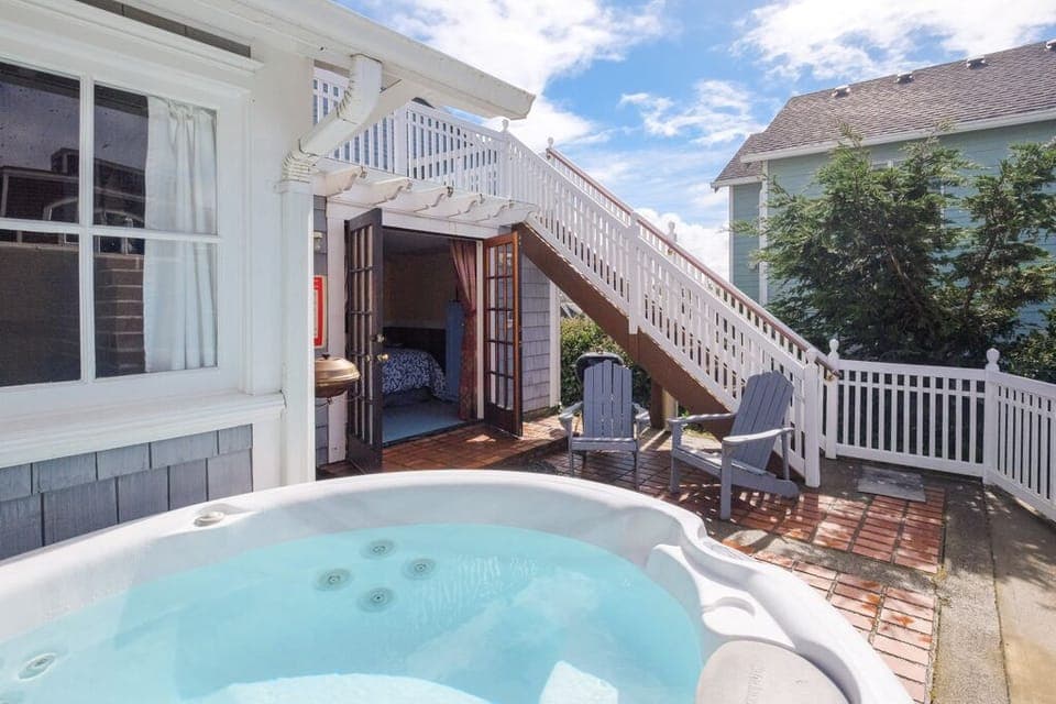 Staircase is to upper deck . Private patio & hot tub - Private deck includes Stainless BBQ, wooden adirondack chairs , upper deck & hot tub.
