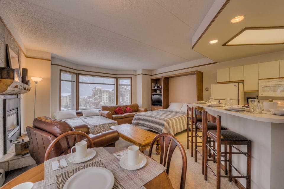 View from dining table with the open Queen Murphy Bed & two open Roll-Away Beds.