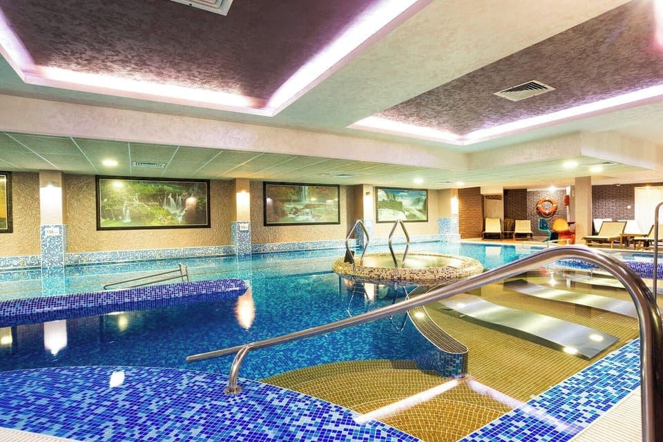 2 indoor pools, outdoor pool, open 9:00 AM to 8:00 PM, pool umbrellas