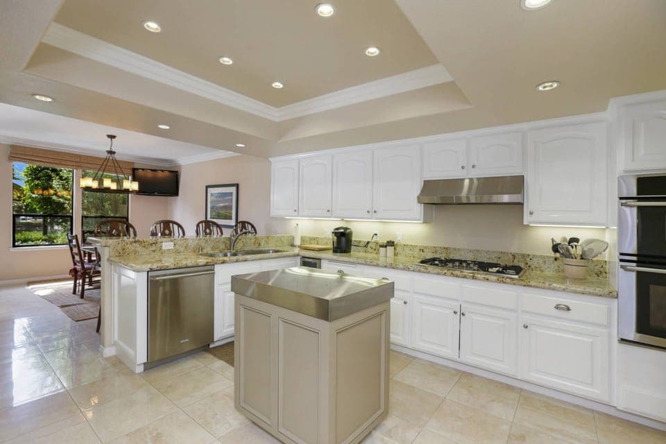 The kitchen is open and bright - counter seating to mingle with the cook as they prepare the meal.