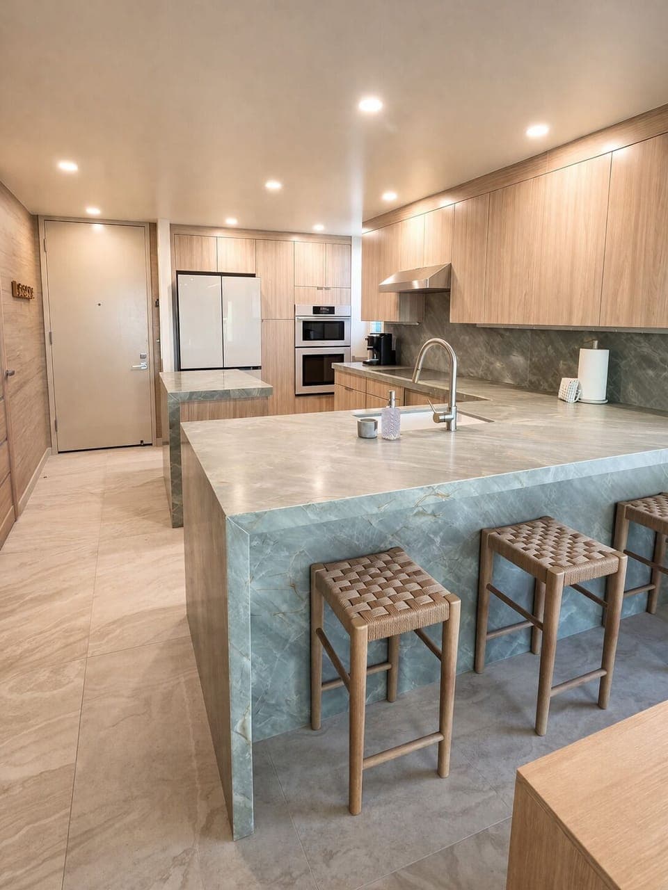Enjoy a state-of-the-art refrigerator with a beverage center, autofill water pitcher, and multiple ice options. The kitchen also features new Samsung appliances and island seating with three barstools.
