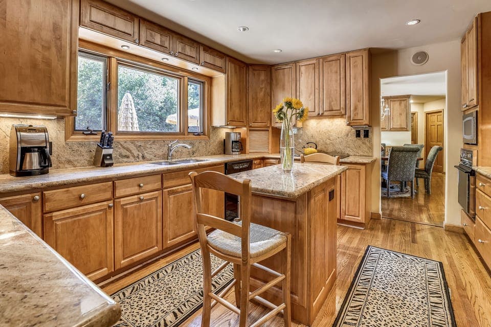 Large open upstairs kitchen overlooks back deck