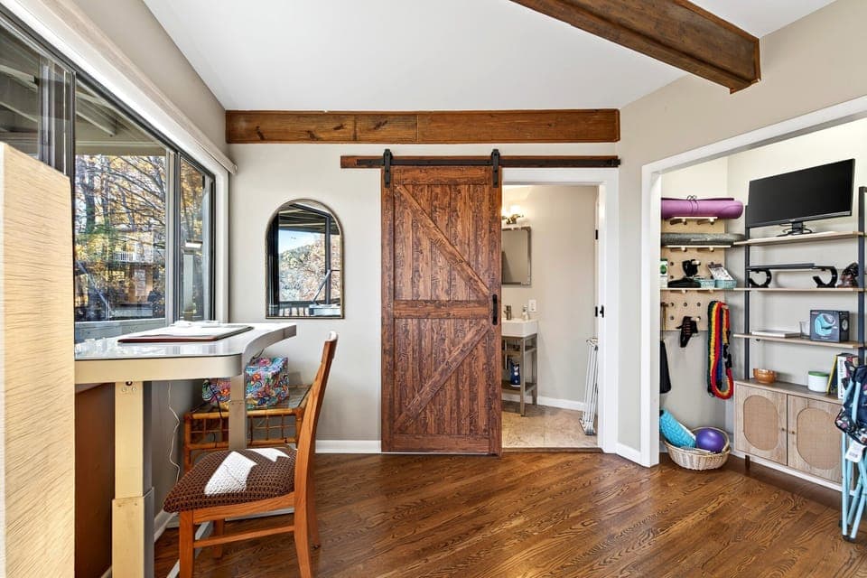 Dedicated workstation and closet with yoga mats/accessories.