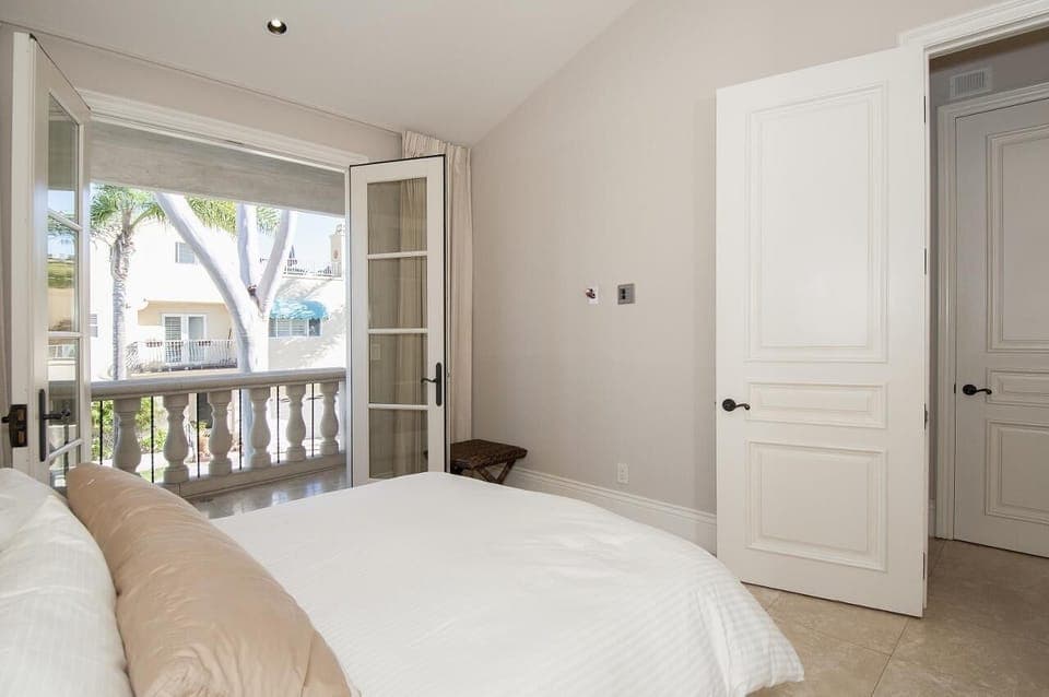 private bedroom suite on main level (2nd level) opens to a cozy balcony