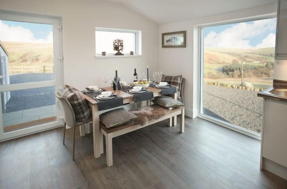 Ground floor: Open-plan kitchen/dining area with underfloor heating and large floor to ceiling window overlooking the surrounding countryside