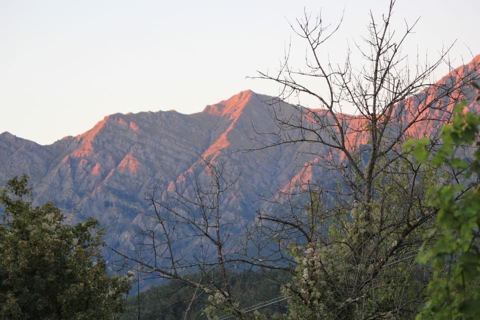 View of the sun setting behind the mountains