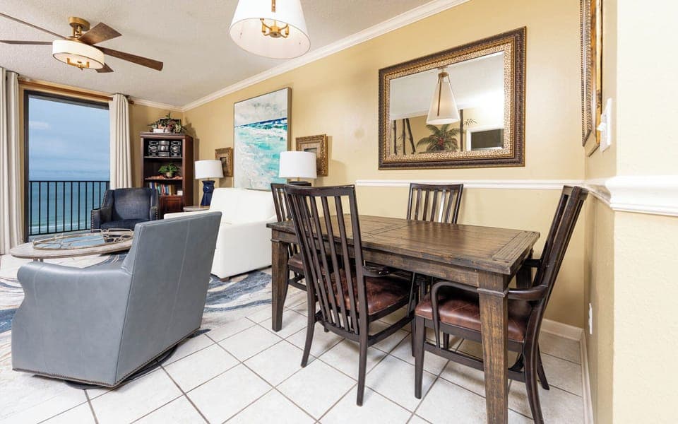 Enjoy meals at the rustic dining table, surrounded by tasteful decor and a cozy living area with beach views