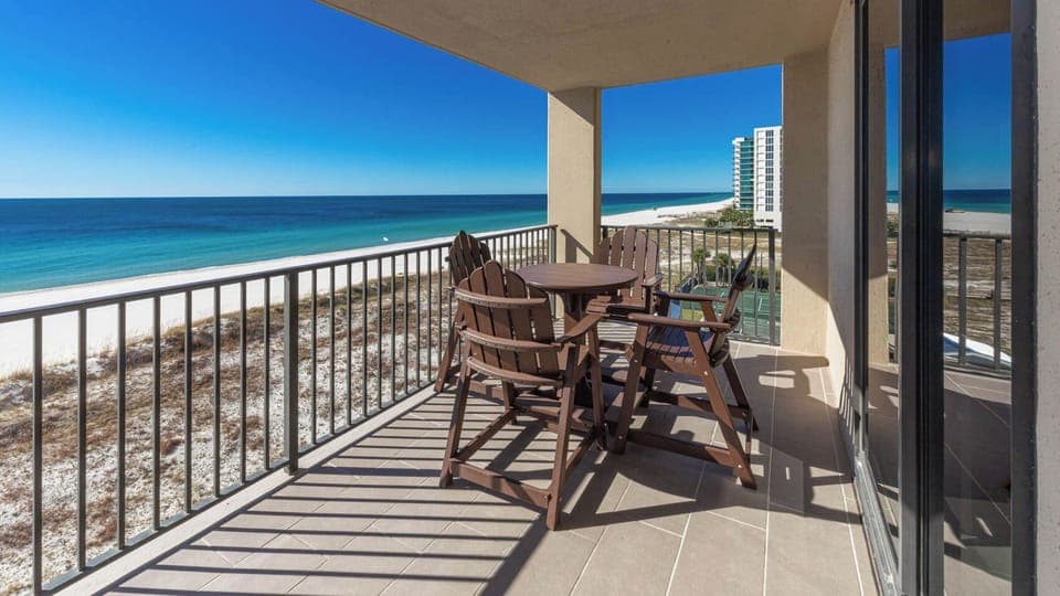 Enjoy the view from the outdoor balcony area, perfect for relaxing with a drink while soaking in the coastal scenery
