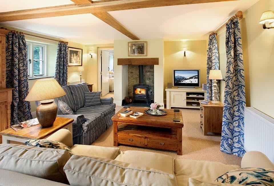 Ground floor:  Sitting room with beamed fireplace and wood burning stove with doors to the garden area