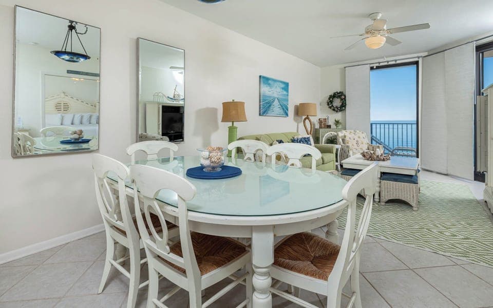 Gather around the oval dining table, enjoying the inviting decor and beach light streaming through the windows