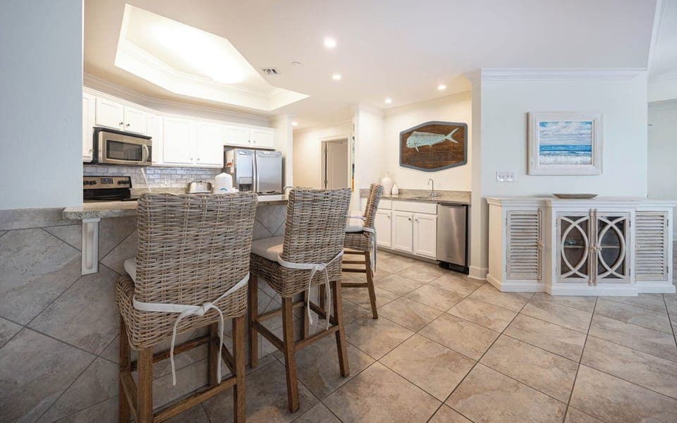 The kitchen features stainless appliances, granite countertops, and a stylish bar, perfect for casual dining and entertaining