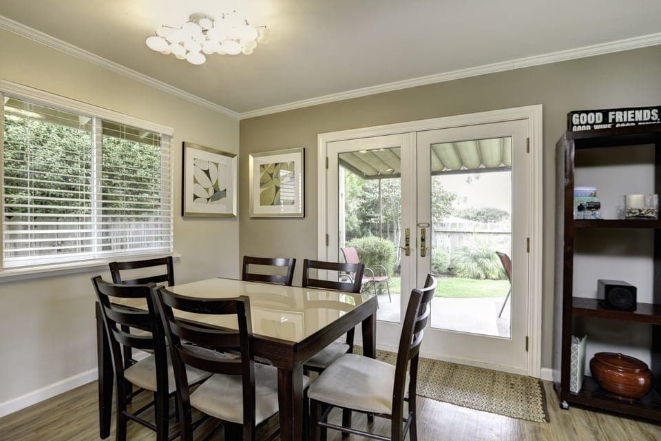 Experience seamless indoor-outdoor living as double doors off the dining room unveil a private, beautifully landscaped backyard oasis.