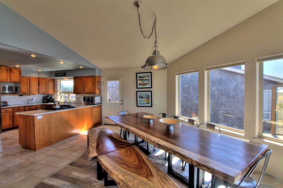 Both the stunning dining area and the amazing kitchen share the stunning vistas.