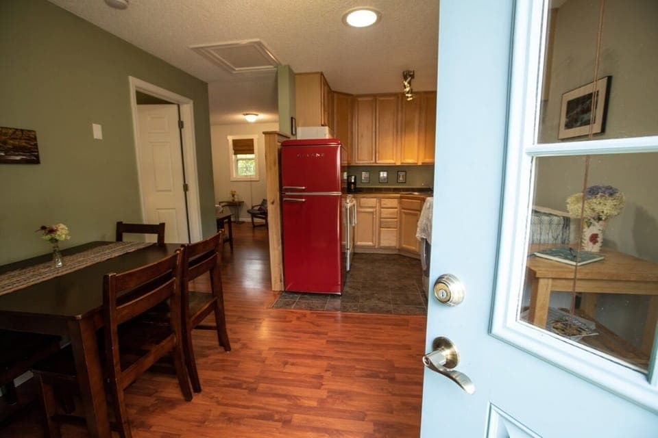 Entrance view of kitchen, bedroom on left and living room/sofa bed thru hallway.