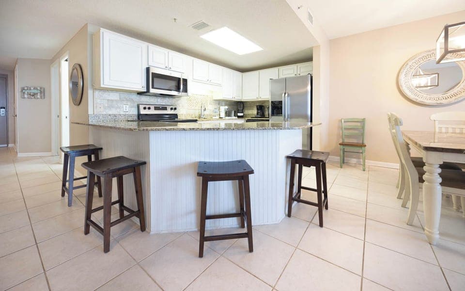 Gather around the spacious kitchen bar with seating, perfect for casual meals and conversations in a welcoming space