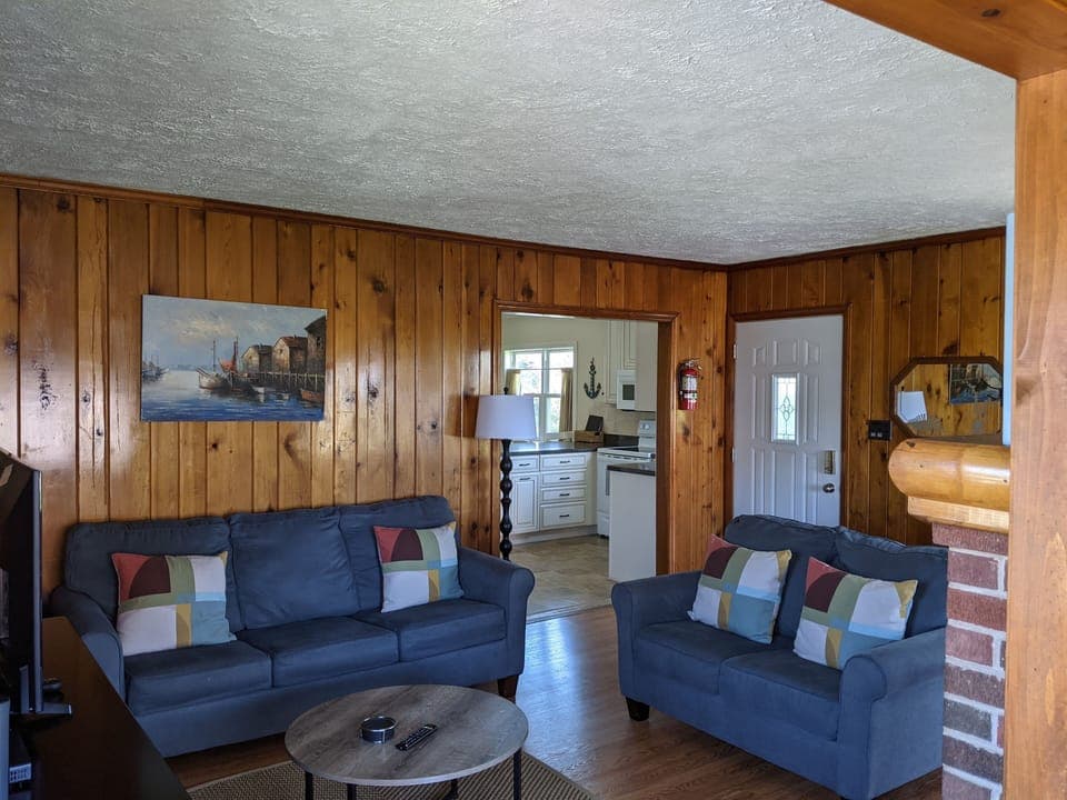 Living room includes couch, love seat, TV