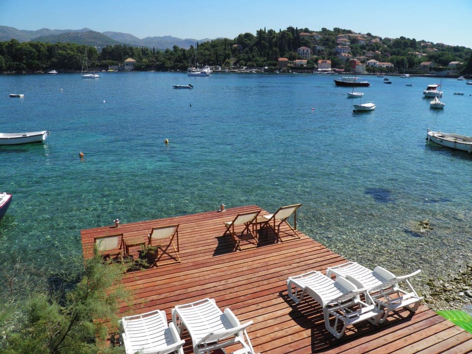 Private wooden pier with the beach in front of the house