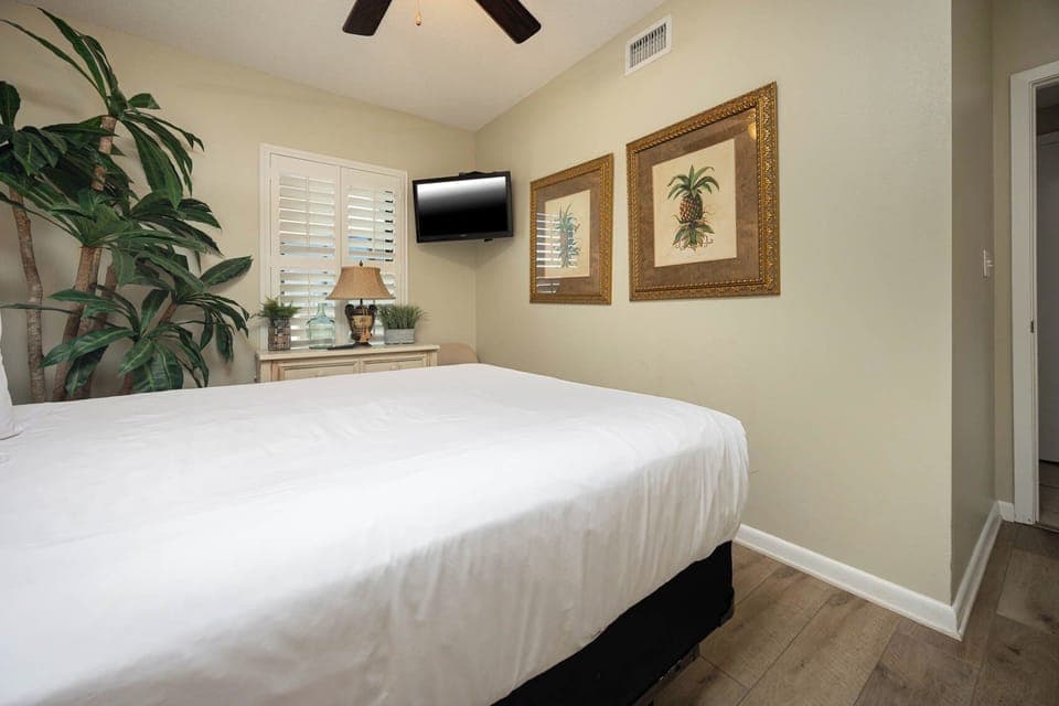 inviting guest bedroom featuring a queen bed, a TV, and decorative accents for a restful stay