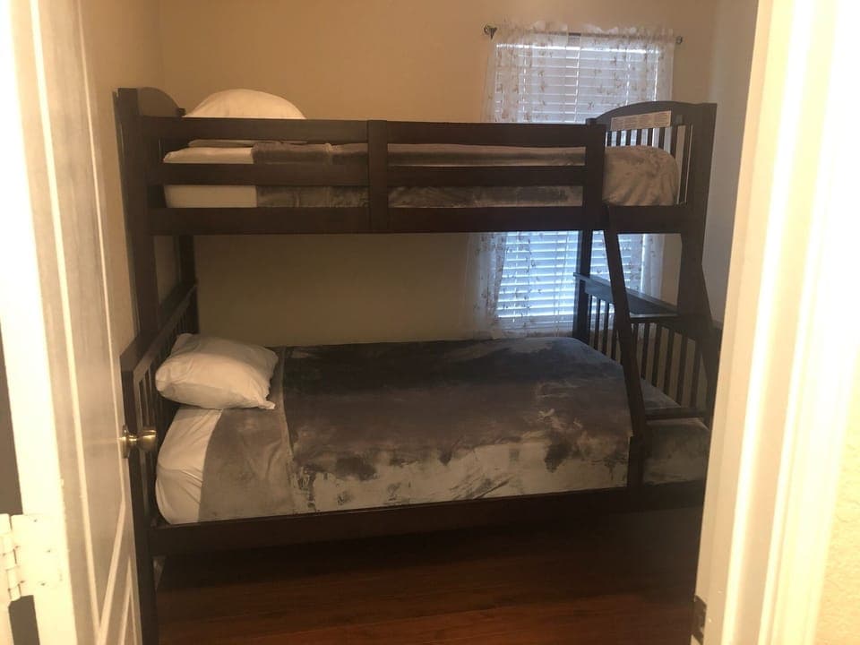 Guest bedroom with bunk beds. Full bed on bottom twin bed on top. Sleeps 2-3 ppl