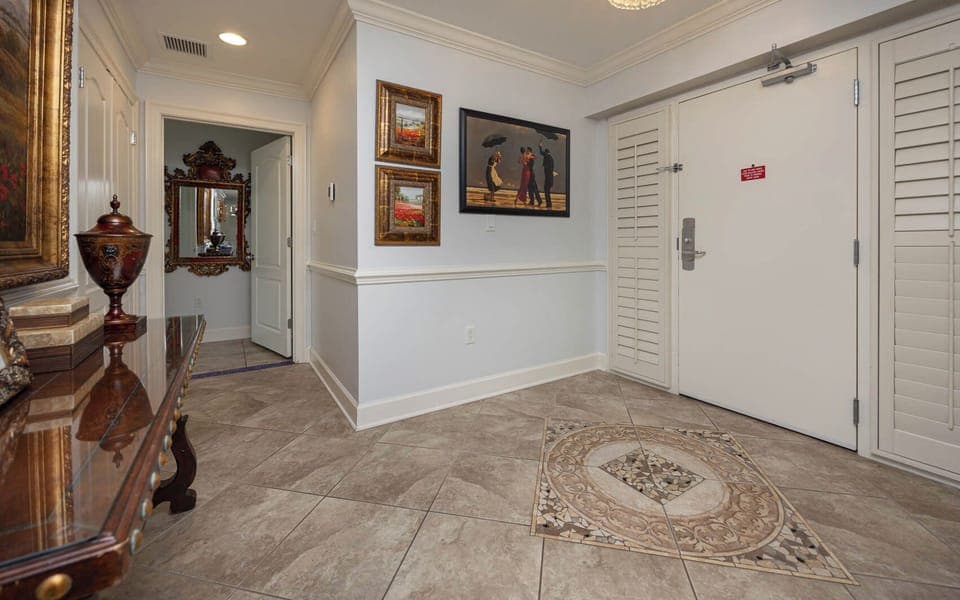 This elegant entryway features decorative artwork, a stylish console table, and a welcoming atmosphere for guests