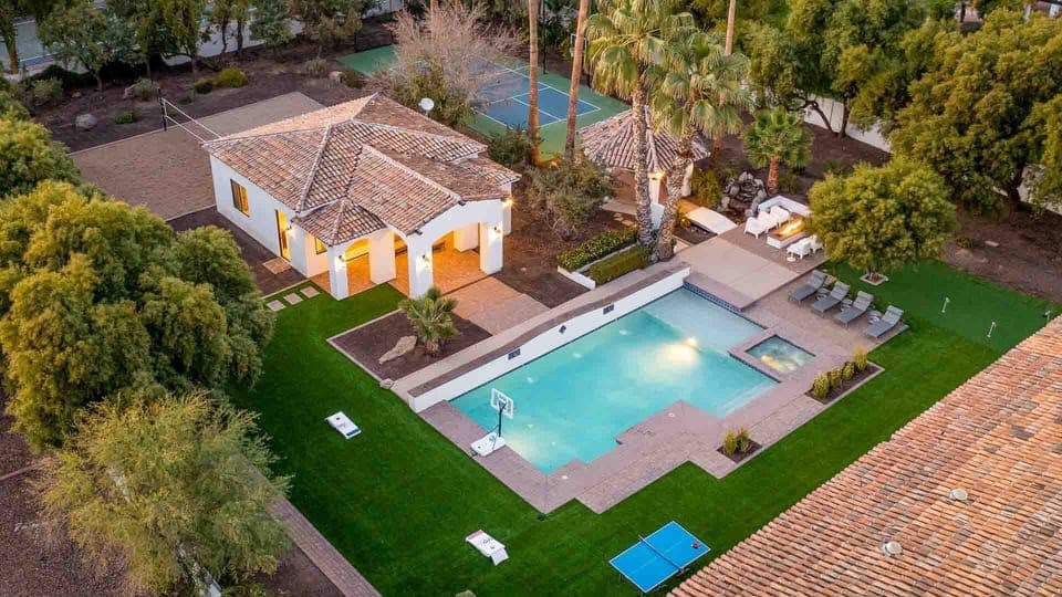 Expansive backyard with a pool, spa, sport court, and plenty of space to play.