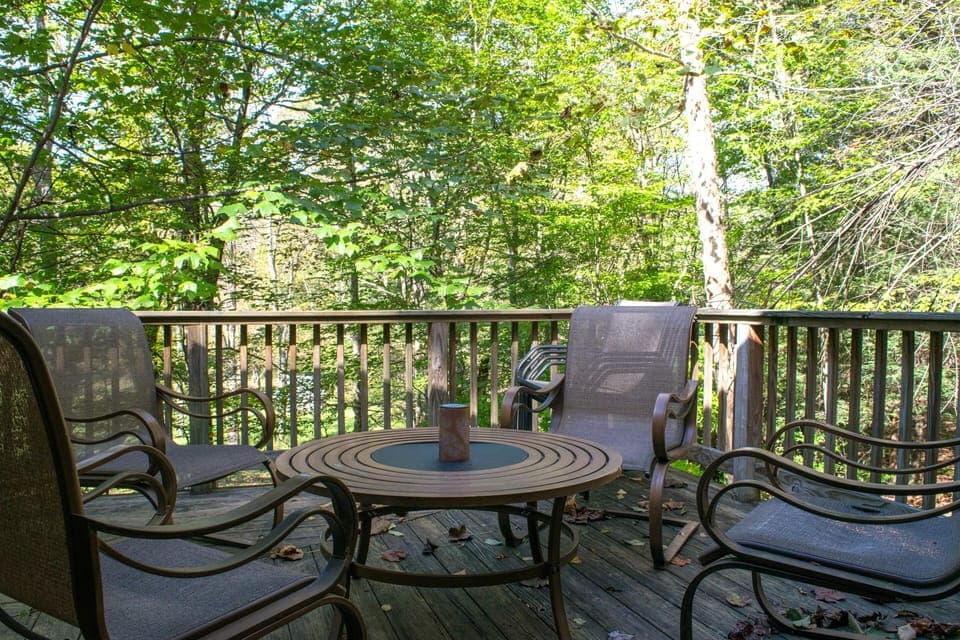 utdoor social seating on the back deck overlooking the river.