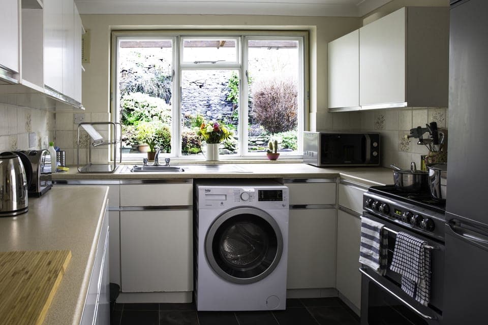 The well equipped kitchen with washer/dryer and overlooks the private garden