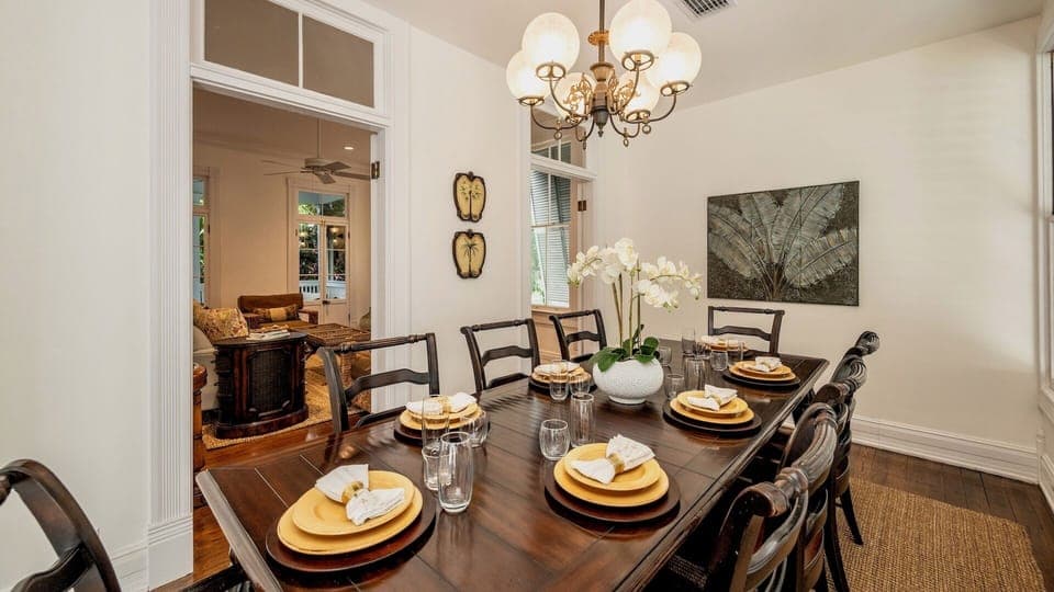 The formal dining room has a large table with seating for 8...