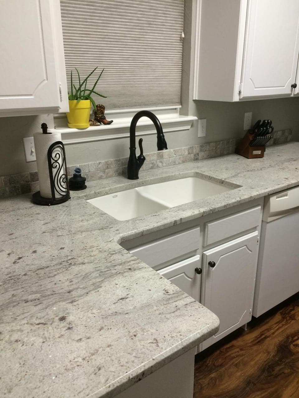 Granite countertops glisten in the sunny dine-in kitchen.
