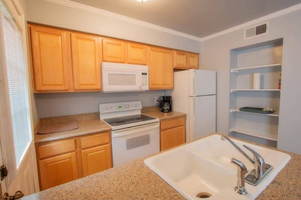 Fully equipped kitchen with pots, pans, plates, bowls, utensils, fire extinguisher and everything you need for meals
