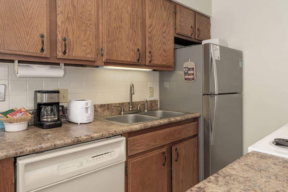 Your fully-equipped kitchen features granite counters, stainless appliances, and rich oak cabinets—perfect for preparing meals during your stay.
