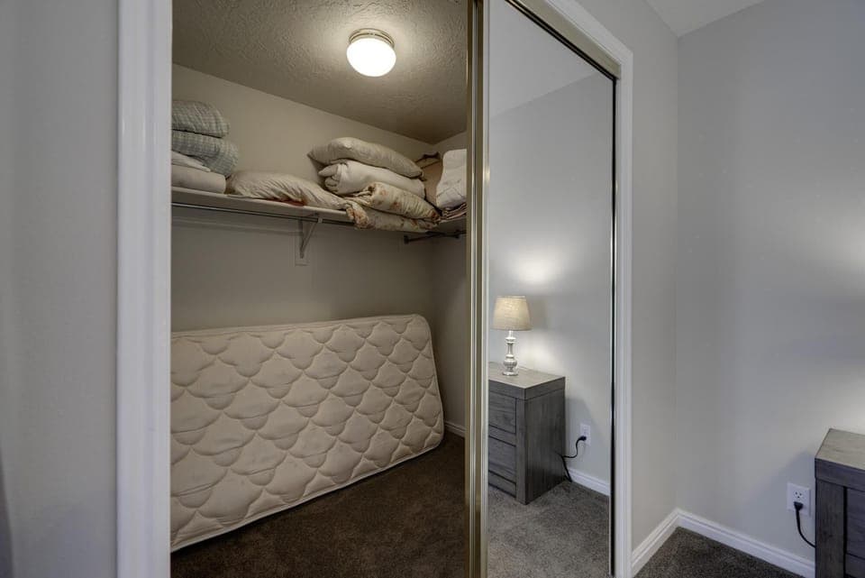 Master bedroom walk-in closet.  Twin mattress for extra sleeping.