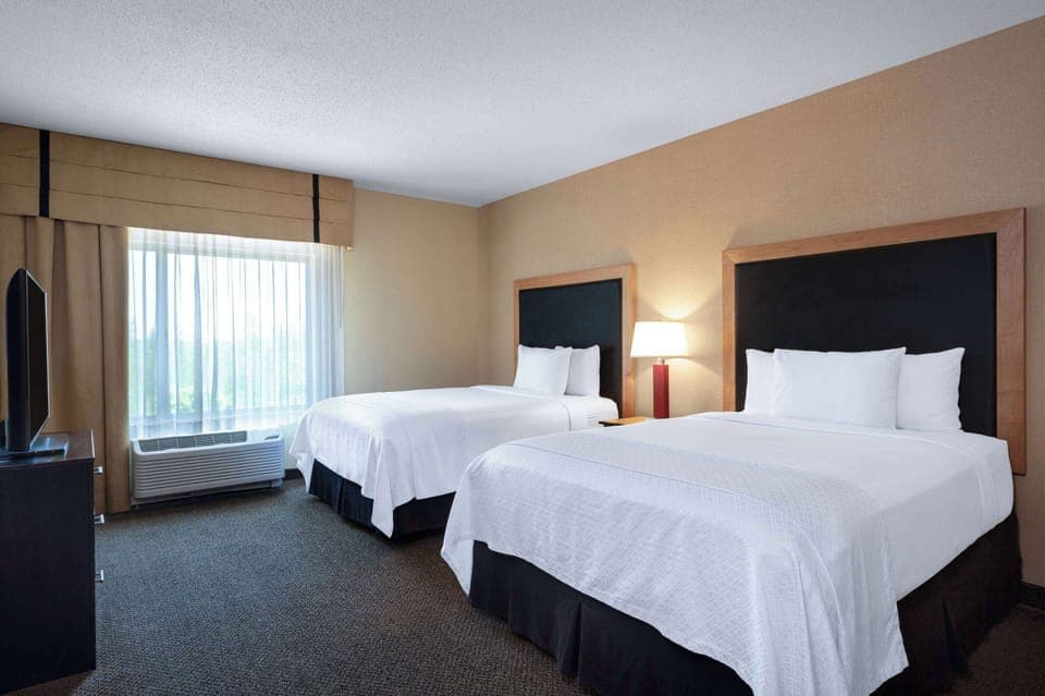 Suite, 2 Queen Beds, Non Smoking | Desk, laptop workspace, blackout drapes, iron/ironing board