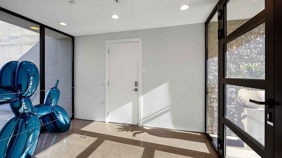 Front door foyer w/ beautiful glass door & unique balloon animal art piece