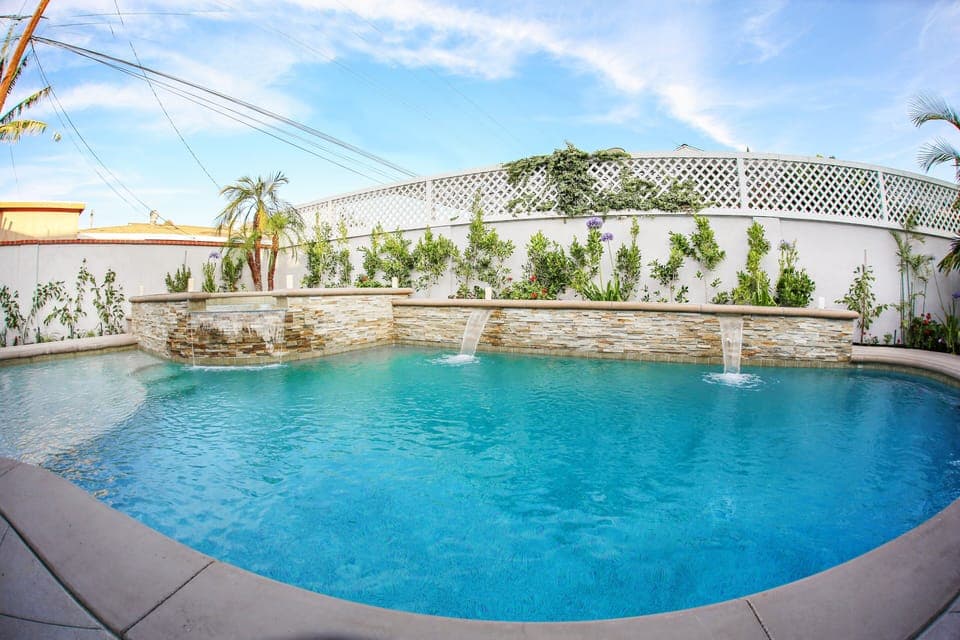 In-ground Pool and Spa with Waterfall Features and Baja Shelf