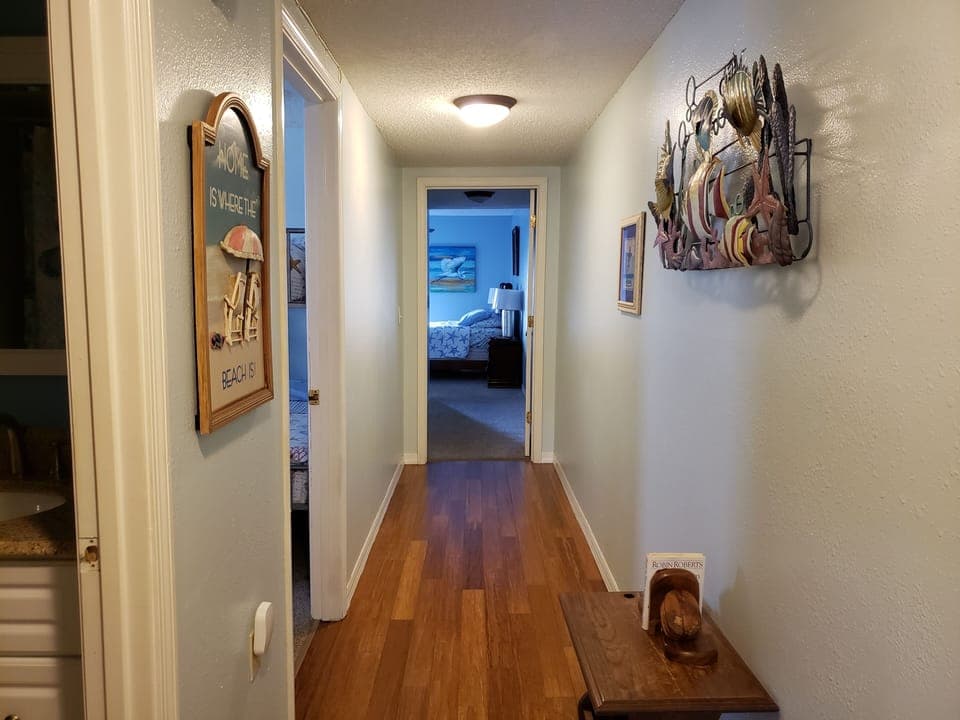 This hall separates the living areas and the bedrooms/bathrooms