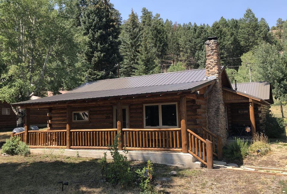 Cabin with National Forest behind it
