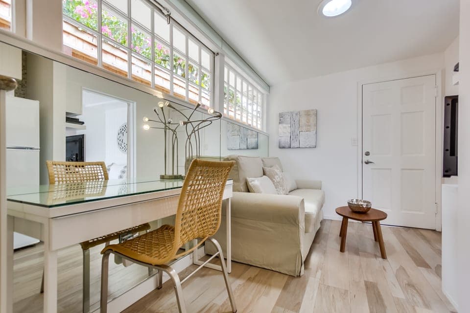 Living area with desk,  full sized sofa, TV and WiFi.