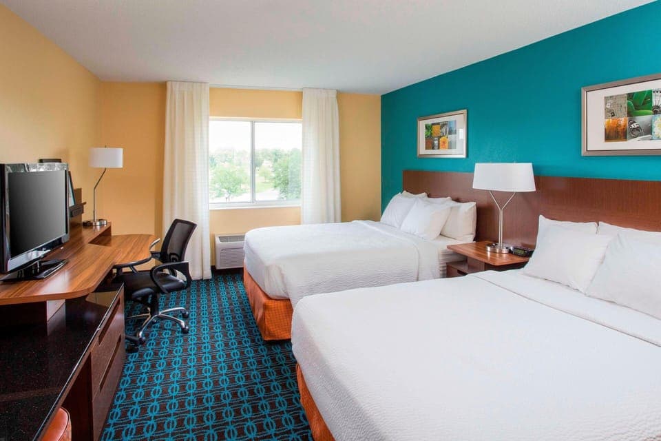 Premium bedding, desk, laptop workspace, blackout drapes