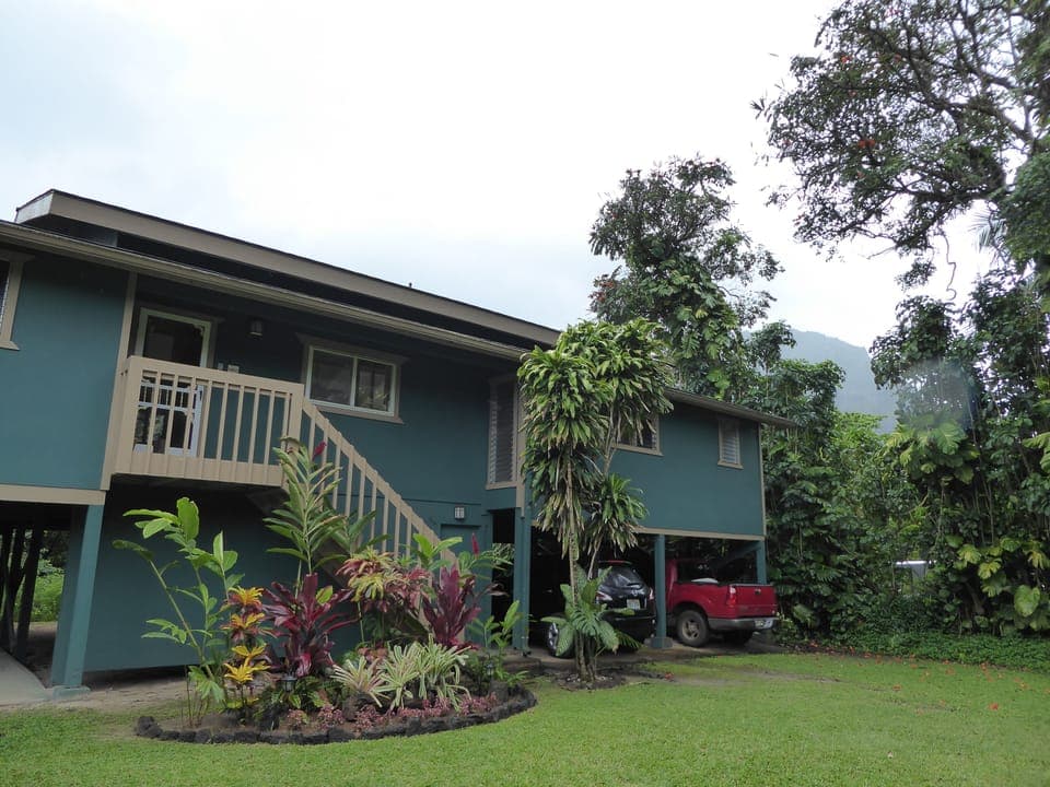 Front of house showing two of the parking spaces under house 