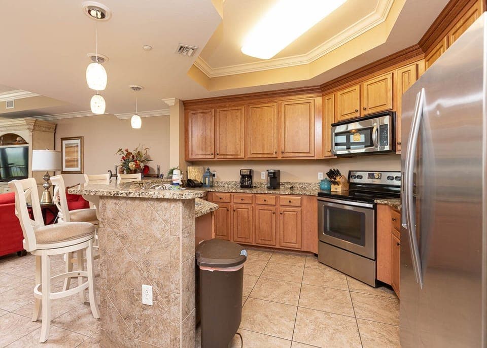 This kitchen features granite countertops, stainless appliances, and a cozy breakfast bar, perfect for morning coffee
